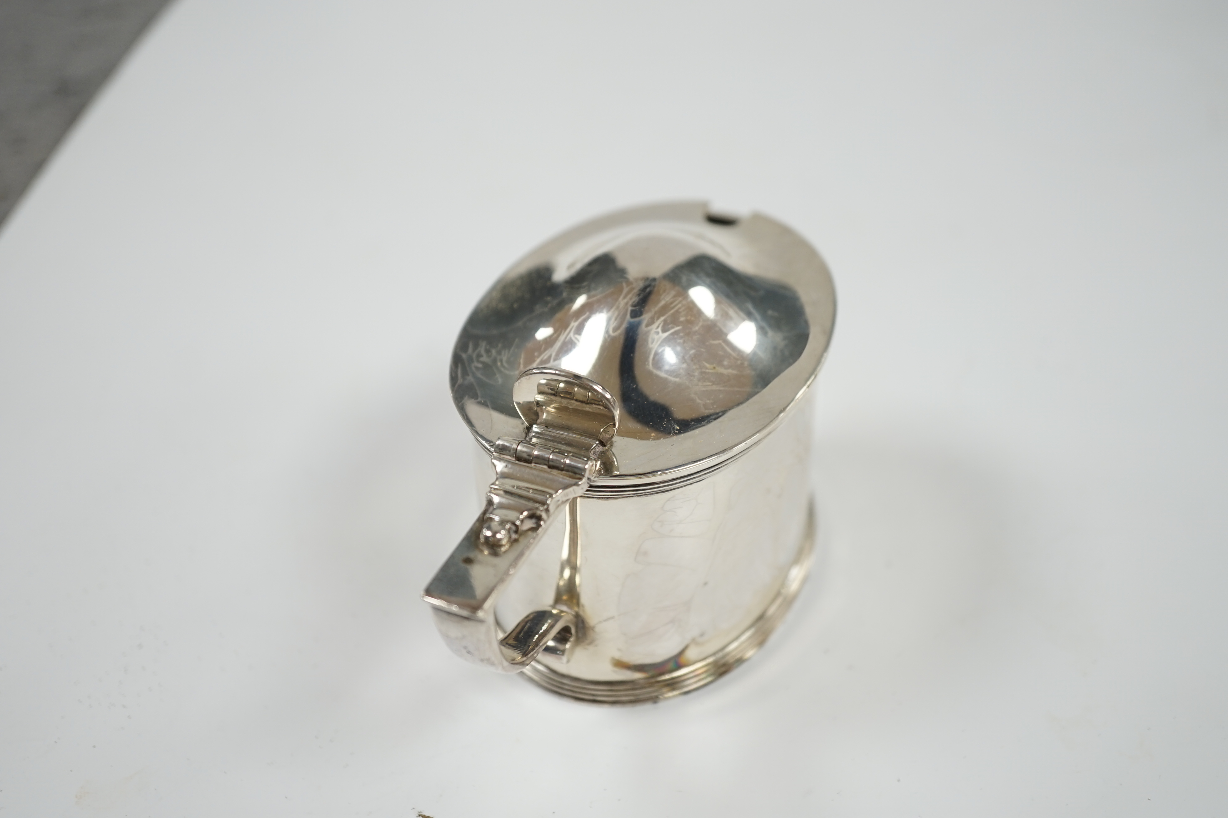 A late Victorian silver oval mustard pot, by William Barnard & Sons, London, 1881, length 10.5cm. Condition - fair